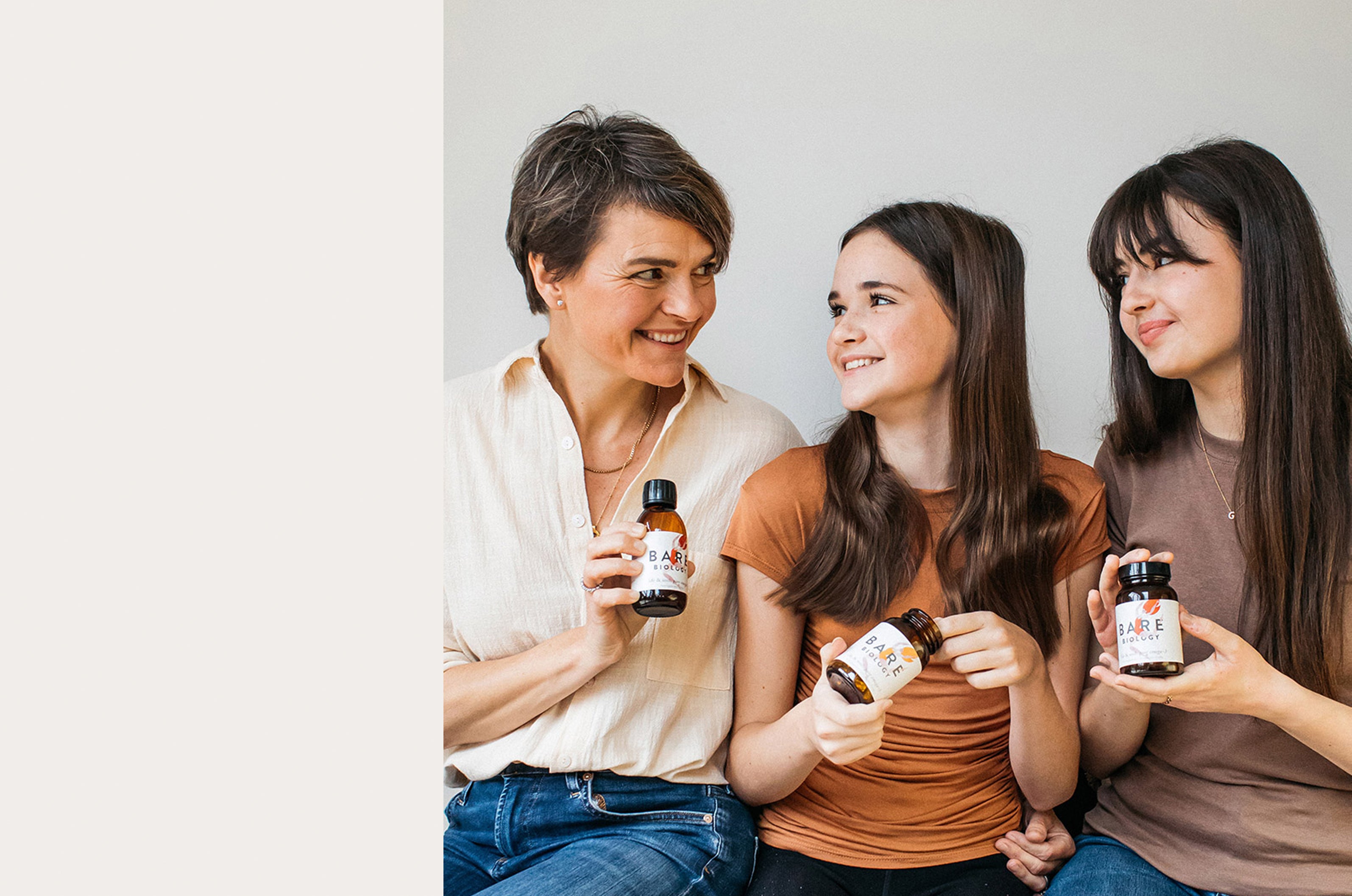 melanie lawson smiling with her two teen daughters and omega-3s from the bare biology range