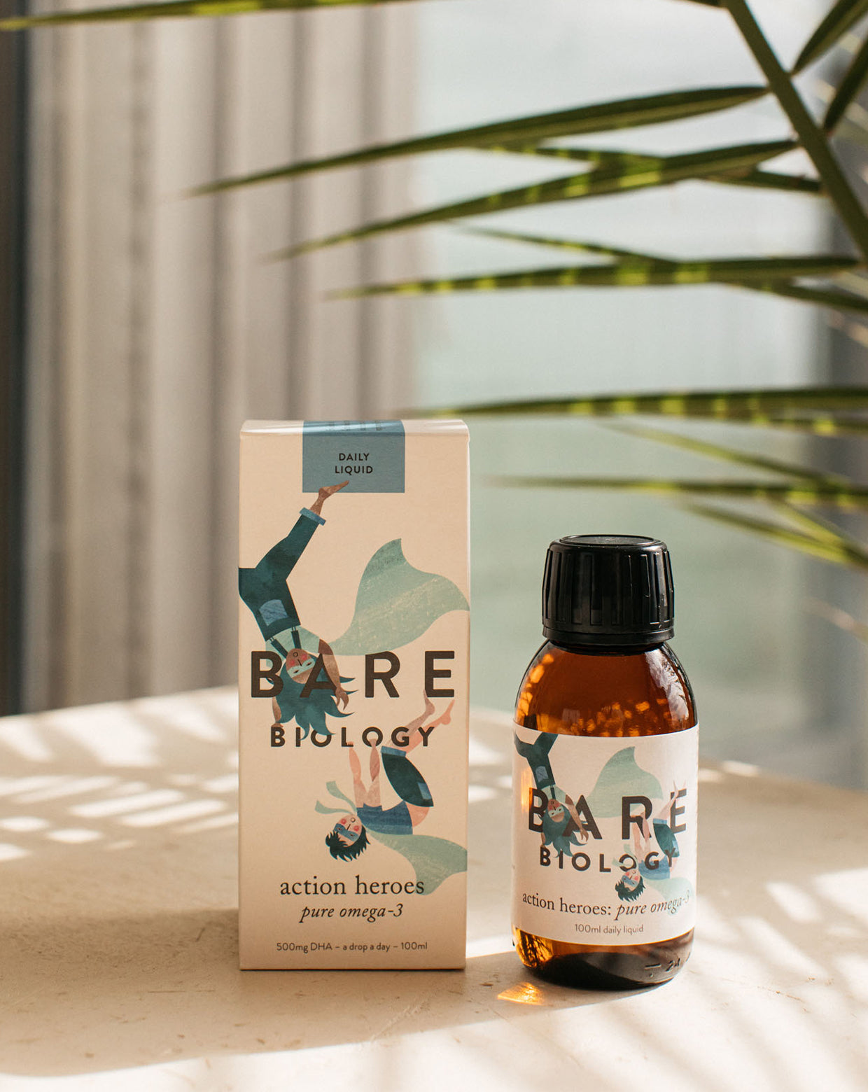 Bare Biology bottle and box on a sunny table with a shadow of a plant.