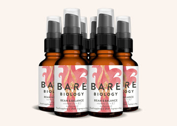 Set of six Bare Biology Beam and Balance vitamin D3 and K2 bottles on a white background