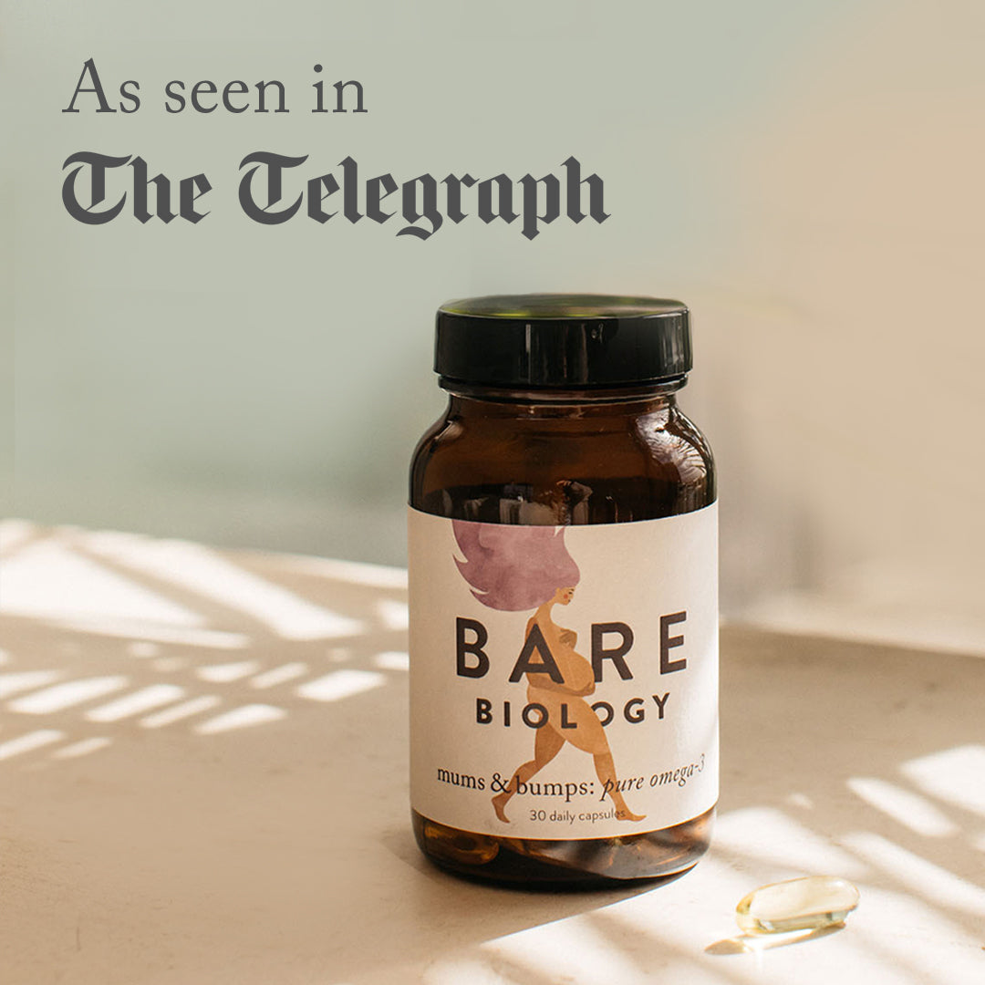a capsule on a sunny table with plant shadows next to a jar of mums and bumps pregnancy capsules. Press feature: As seen in the telegraph in the top left corner.