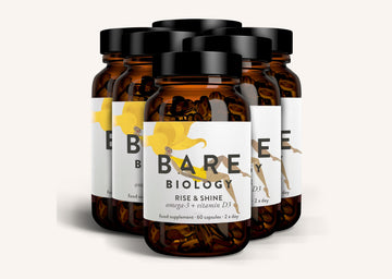 Row of Bare Biology Rise and Shine supplement jars on a wide white background