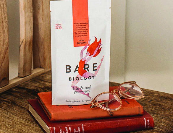 bare biology life & soul omega 3 on a chair with books and glasses