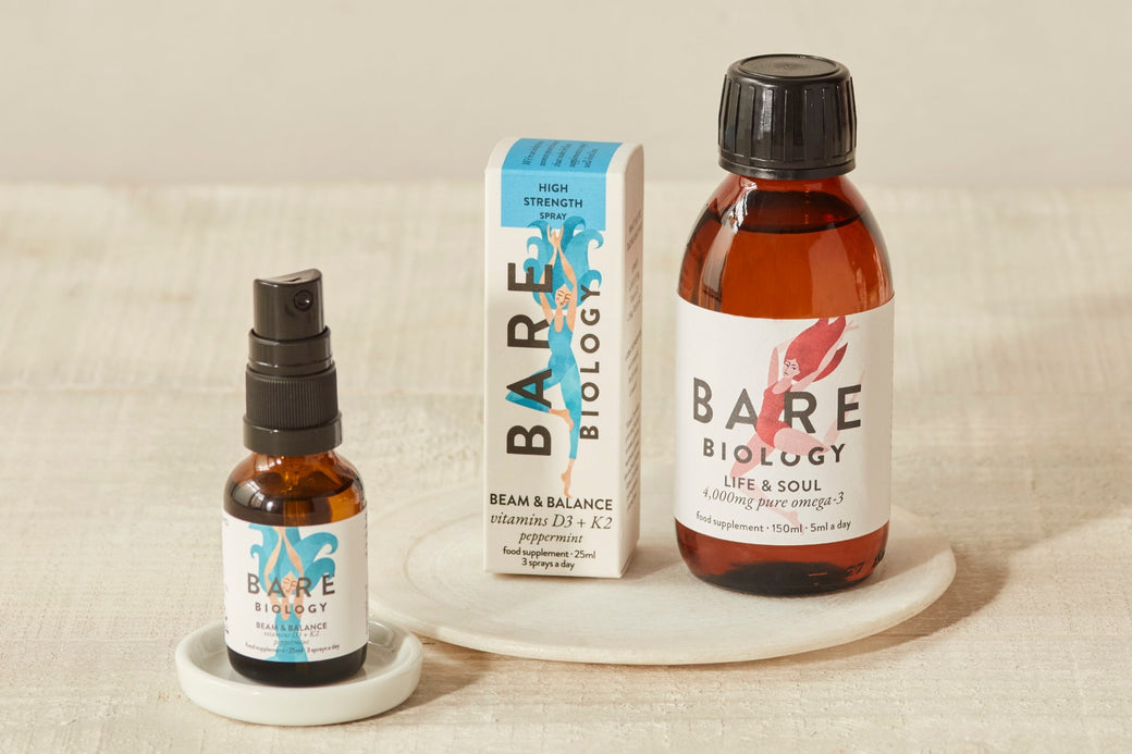 Bare Biology Vitamin D3+K2 and Omega-3 liquid displayed next to each other against a neutral coloured background