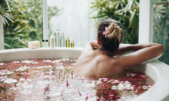 a woman in a bath with flowers