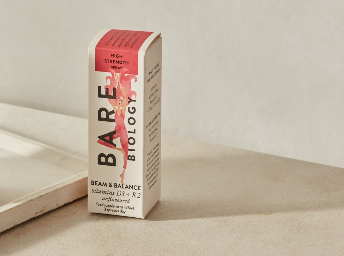 Bare Biology Carton of Vitamin D3 + K2 spray with colourful illustration on the box displayed against a neutral background