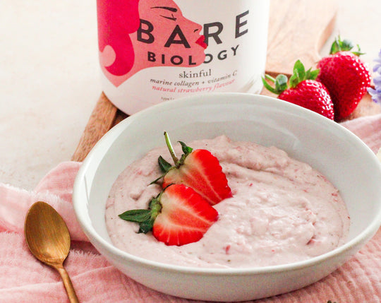 strawberry mousse in a white bowl with chopped strawberries