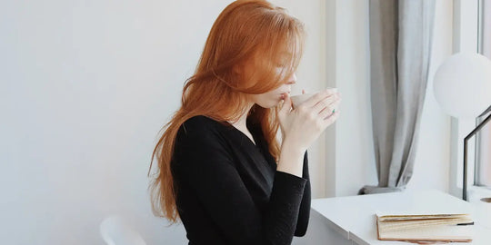 a young woman drinking tea