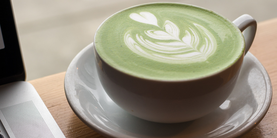 matcha latte in a white teacup