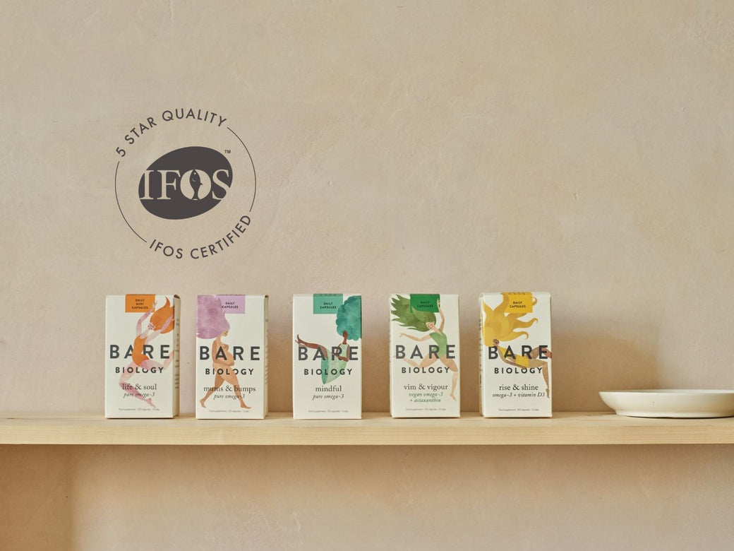 5 Bare Biology products displayed in a line in its colourful packaging on a shelf. IFOS certification logo displayed on the left