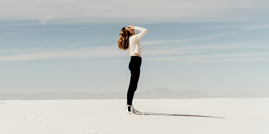 a-woman-standing-on-sand