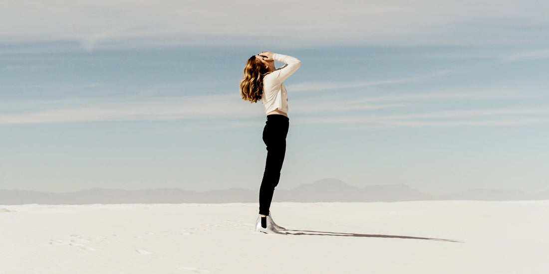 a-woman-standing-on-sand