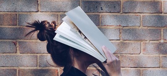 a woman with her head in a book