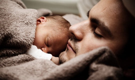 baby asleep with their father