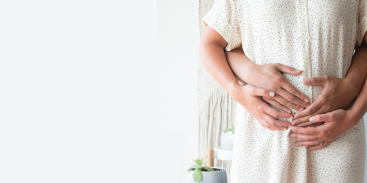 a-couple-hugging-a-pregnant-belly