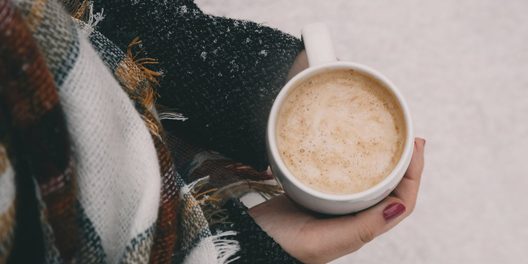 woman-holding-a-frothy-coffee
