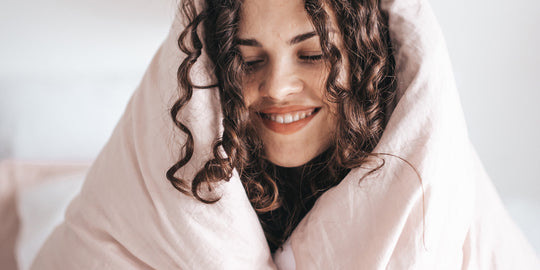 a woman wrapped up in a duvet