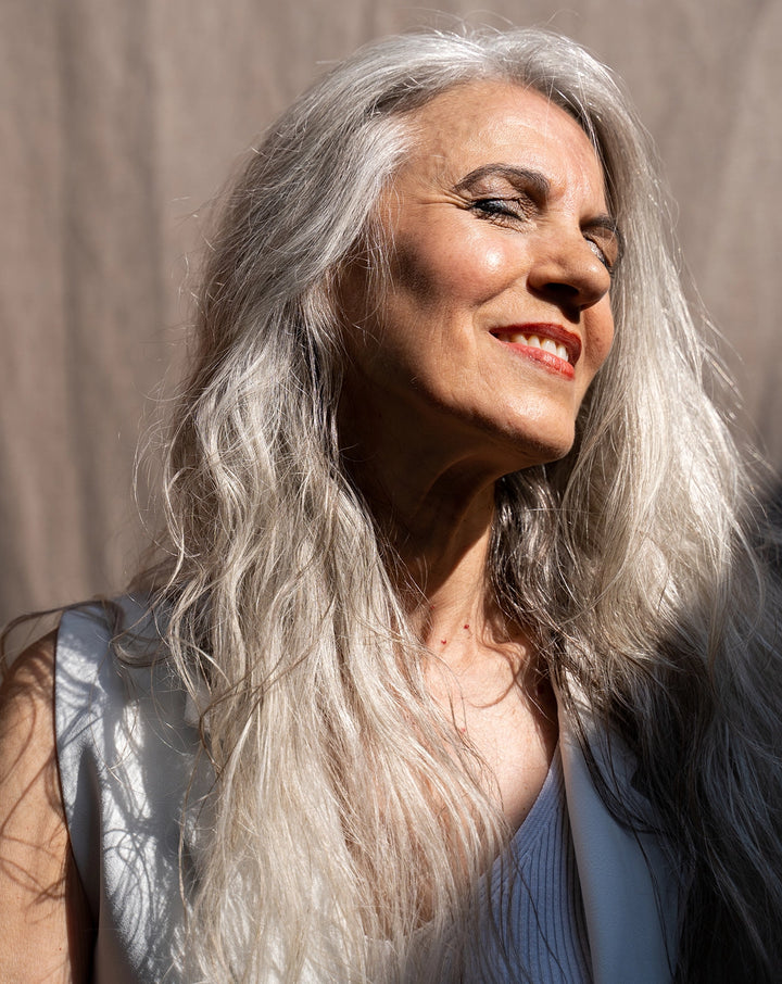 a woman smiling in the sun