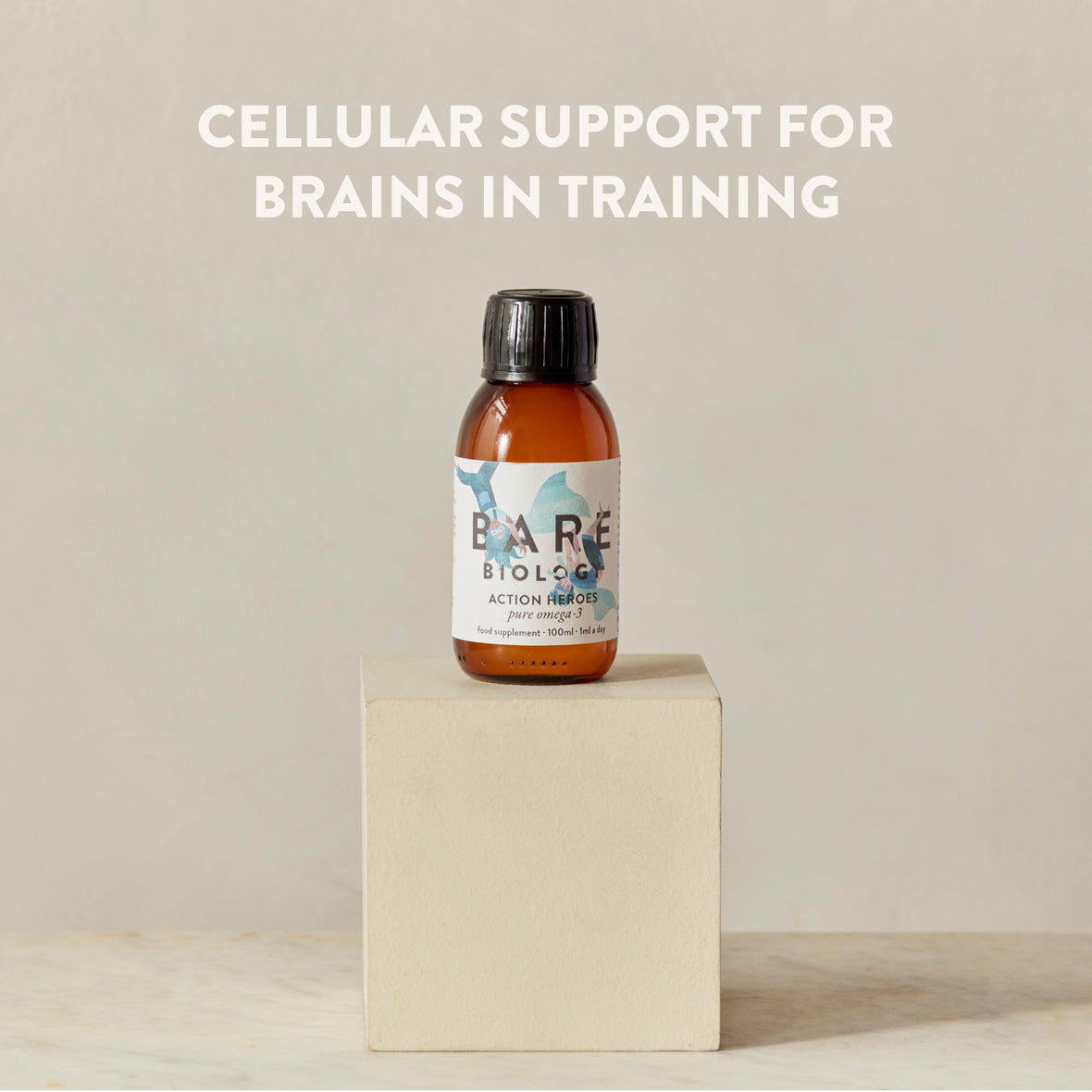 Bottle of Bare Biology Action Heroes Omega-3 fish oil for kids product on a beige block with text 'Cellular Support for Brains in Training' writing on the image on a beige background