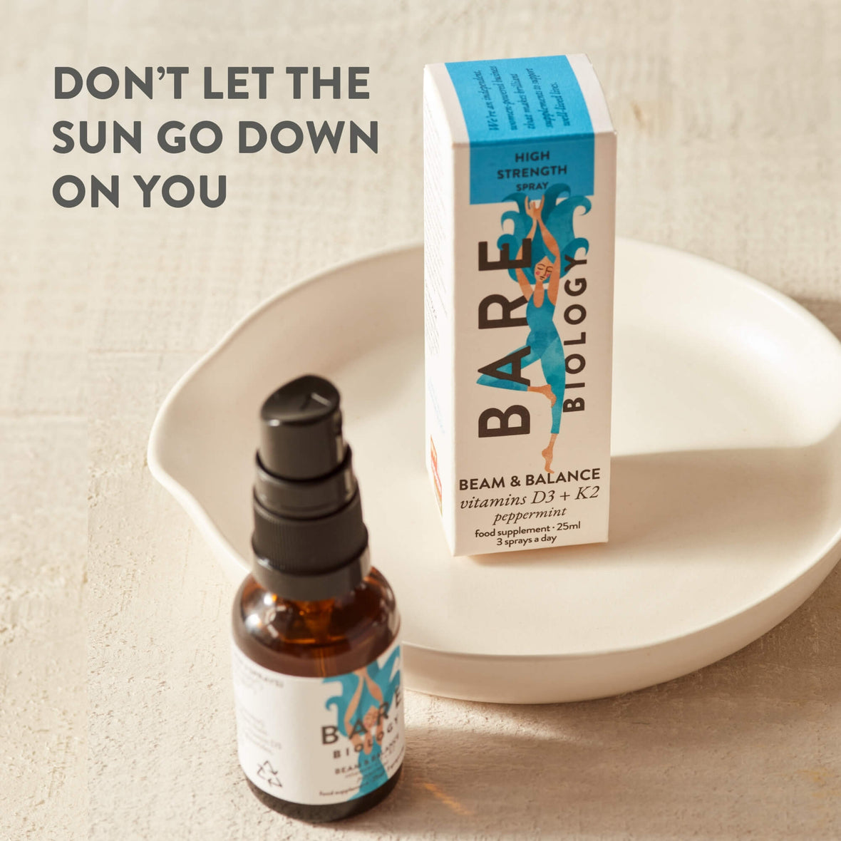 Beam and Balance Spray displayed on a ceramic dish with text Don't let the sun go down on you written in the left hand corner