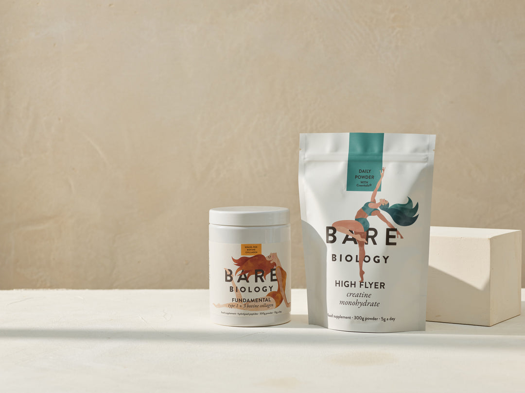 One tub of Bare Biology Fundamental Collagen placed next to the High Flyer Creatine Pouch with illustrative drawings of women on the packing displayed on a neutral coloured surface and a beige background.