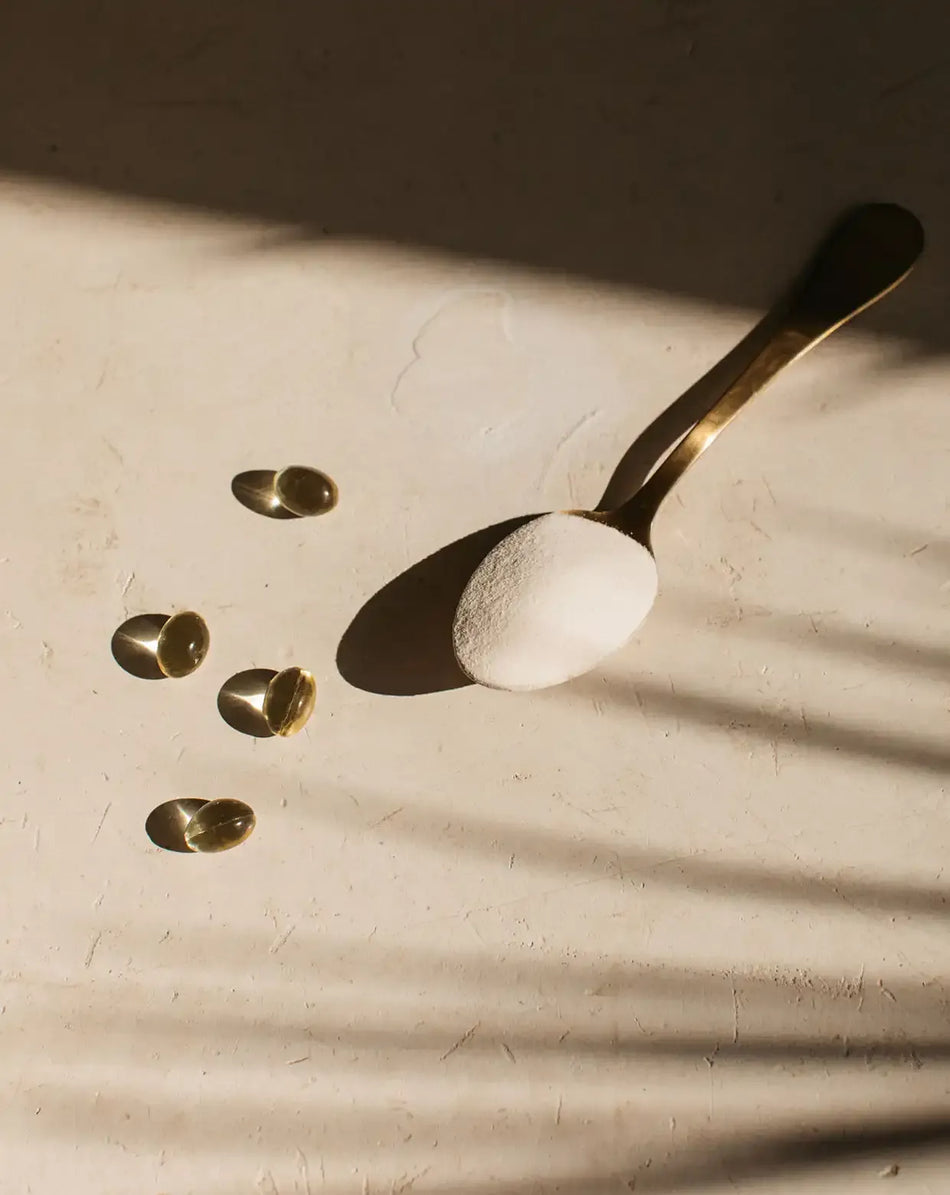 bare biology life & soul mini capsules and skinful marine collagen powder on a spoon in the sun