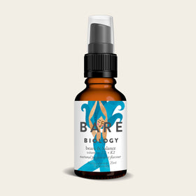 The 25ml Bare Biology Vitamin D3 with Vitamin K2 Spray comes in a small amber bottle with a black pump cap. Featuring blue wave graphics, it highlights vitamin D3 and K2 for immune health and is enhanced with a natural raspberry flavor for delightful wellness support.