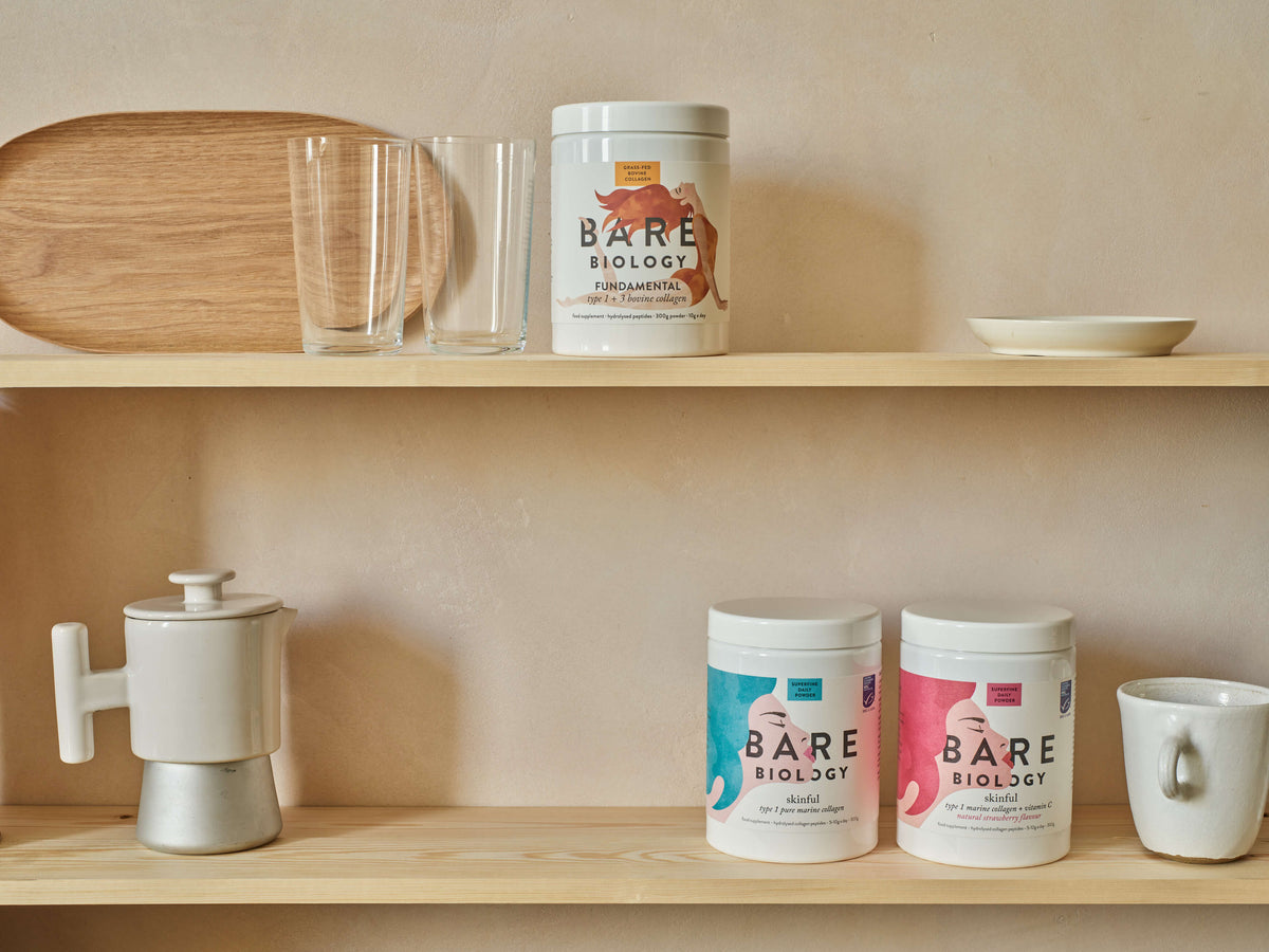 Landscape image of Bare Biology's collagen range displayed on two shelves amongst other crockery
