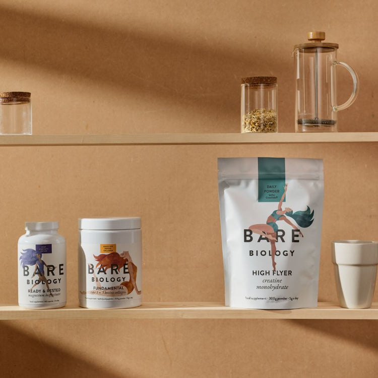 Three Bare Biology products displayed next to each other on a shelf amongst other kitchen items