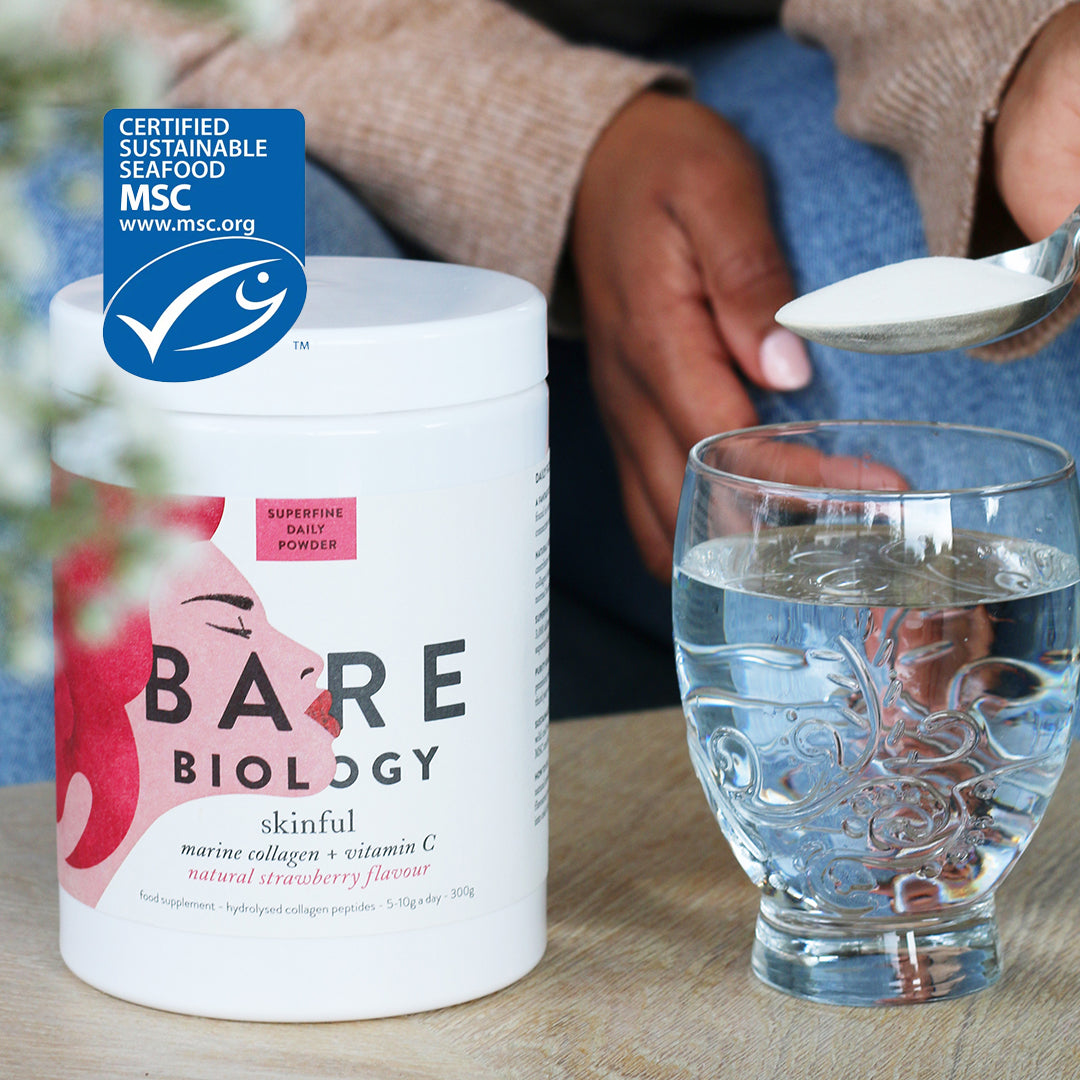 Close up of a lady pouring a spoon of collagen powder into a glass. Bare Biology skinful collagen + vitamin C is to the left with the MSC logo. 