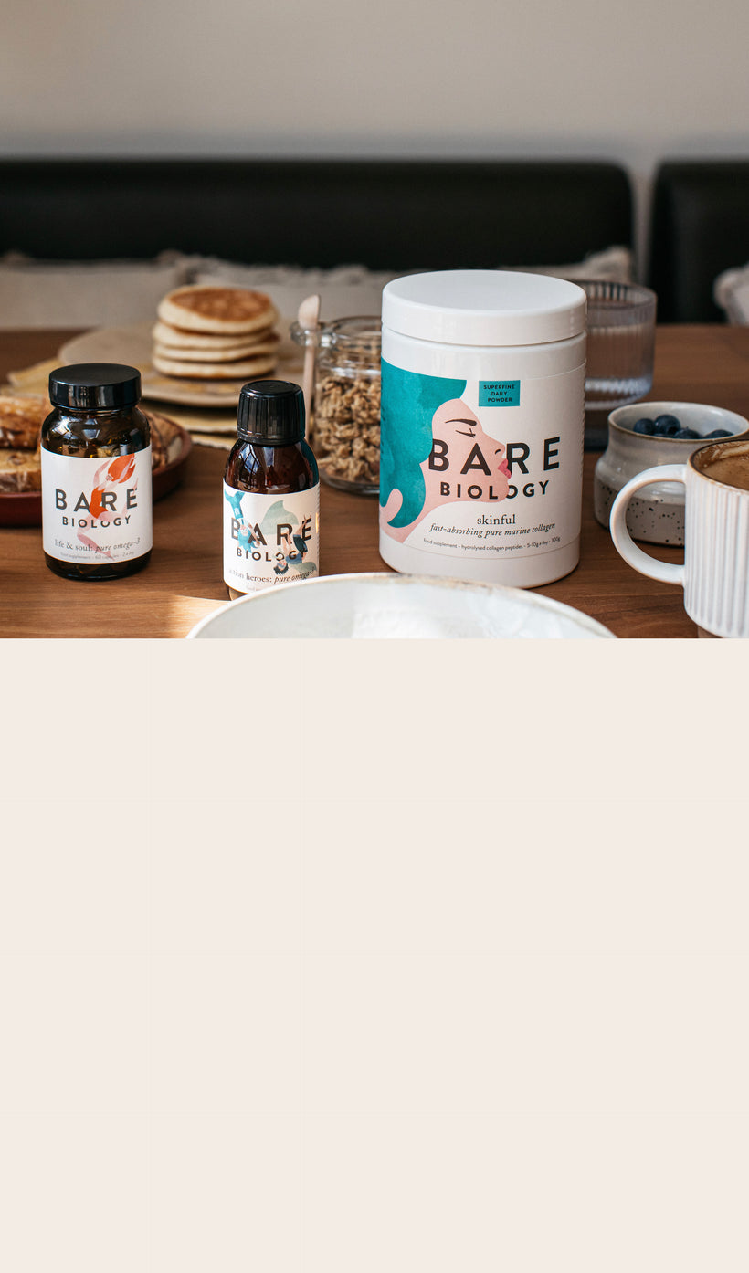 bare biology supplement range on a table with crockery and breakfast foods in the background