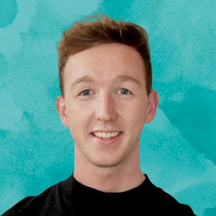 Headshot of Head of Operations wearing a black shirt against a teal background
