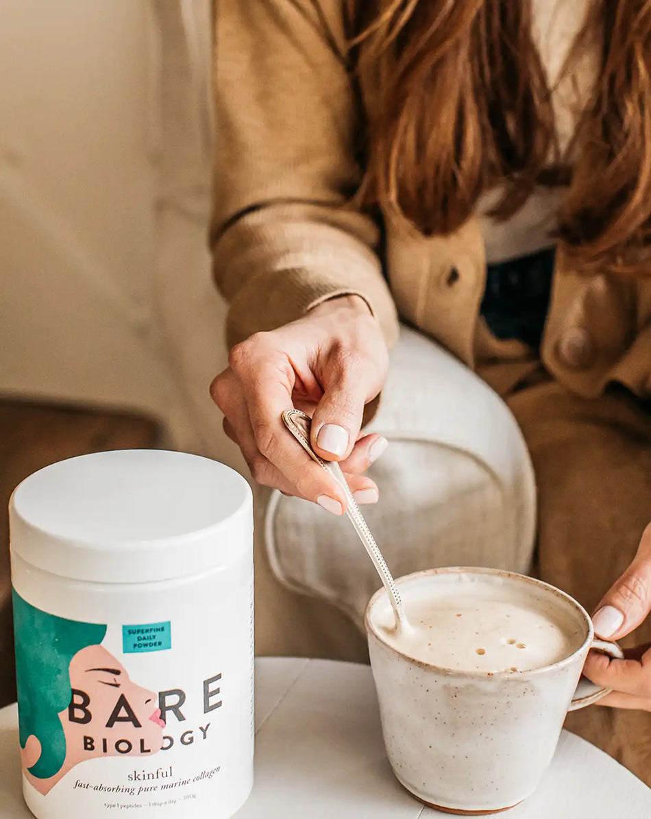 bare biology skinful marine collagen powder being mixed into a coffee by a woman