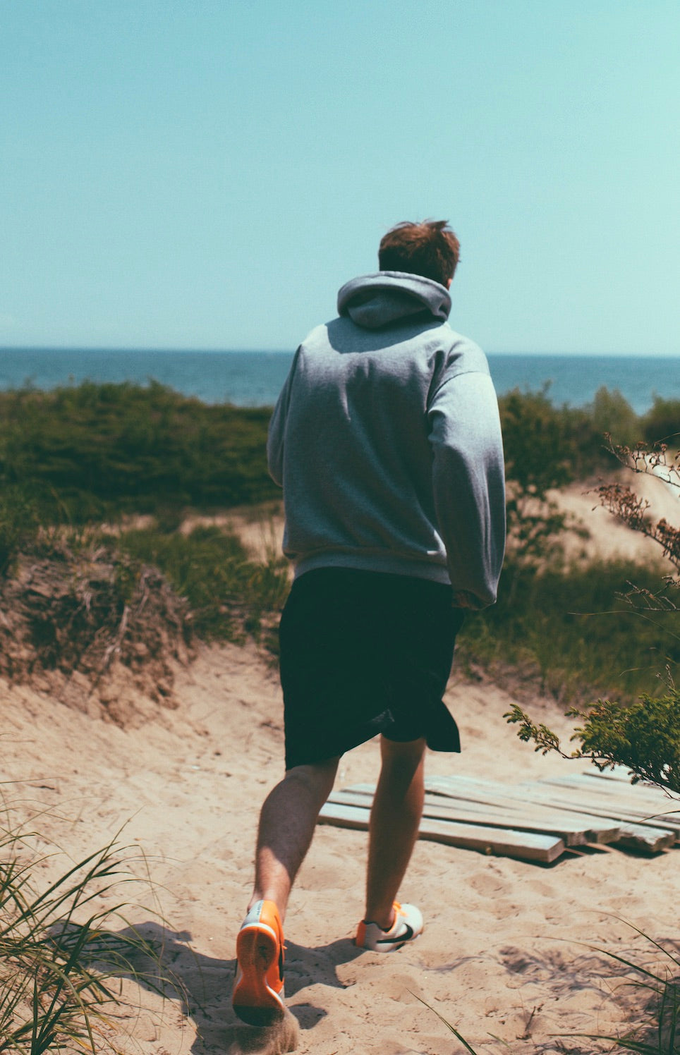 a man running on a sandy beach