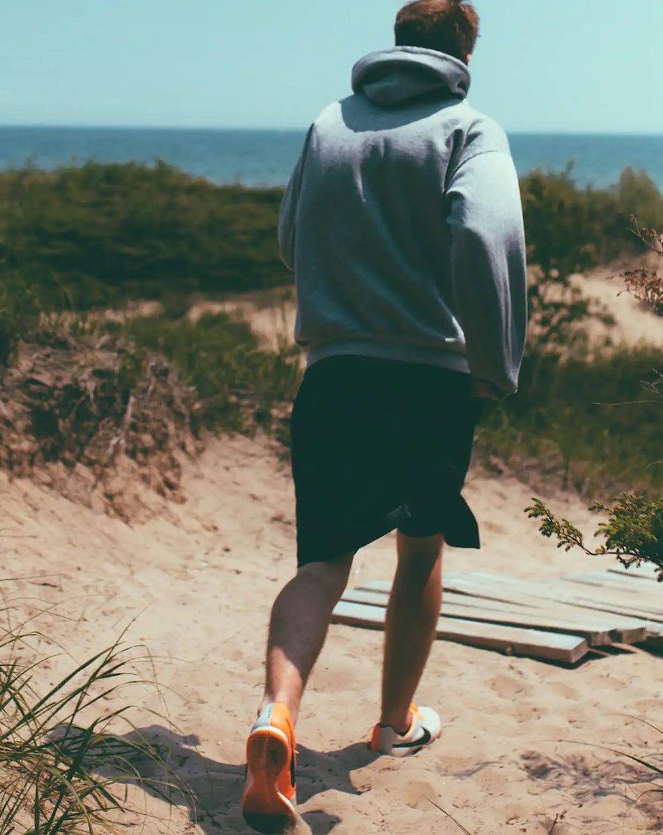 a man running on a sandy beach