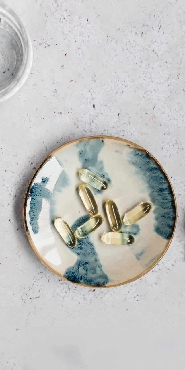 mindful omega 3 capsules for brain health on a blue and white dish
