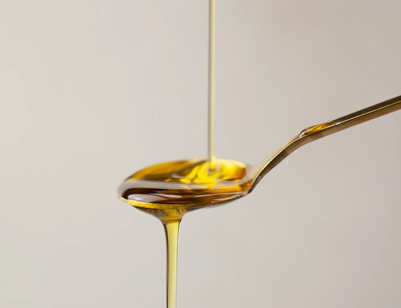 bare biology high strength life & soul omega 3 fish oil liquid pouring on a gold spoon 