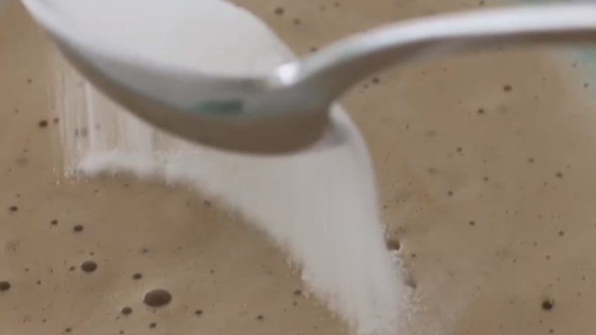 woman making her coffee with bare biology skinful marine collagen powder