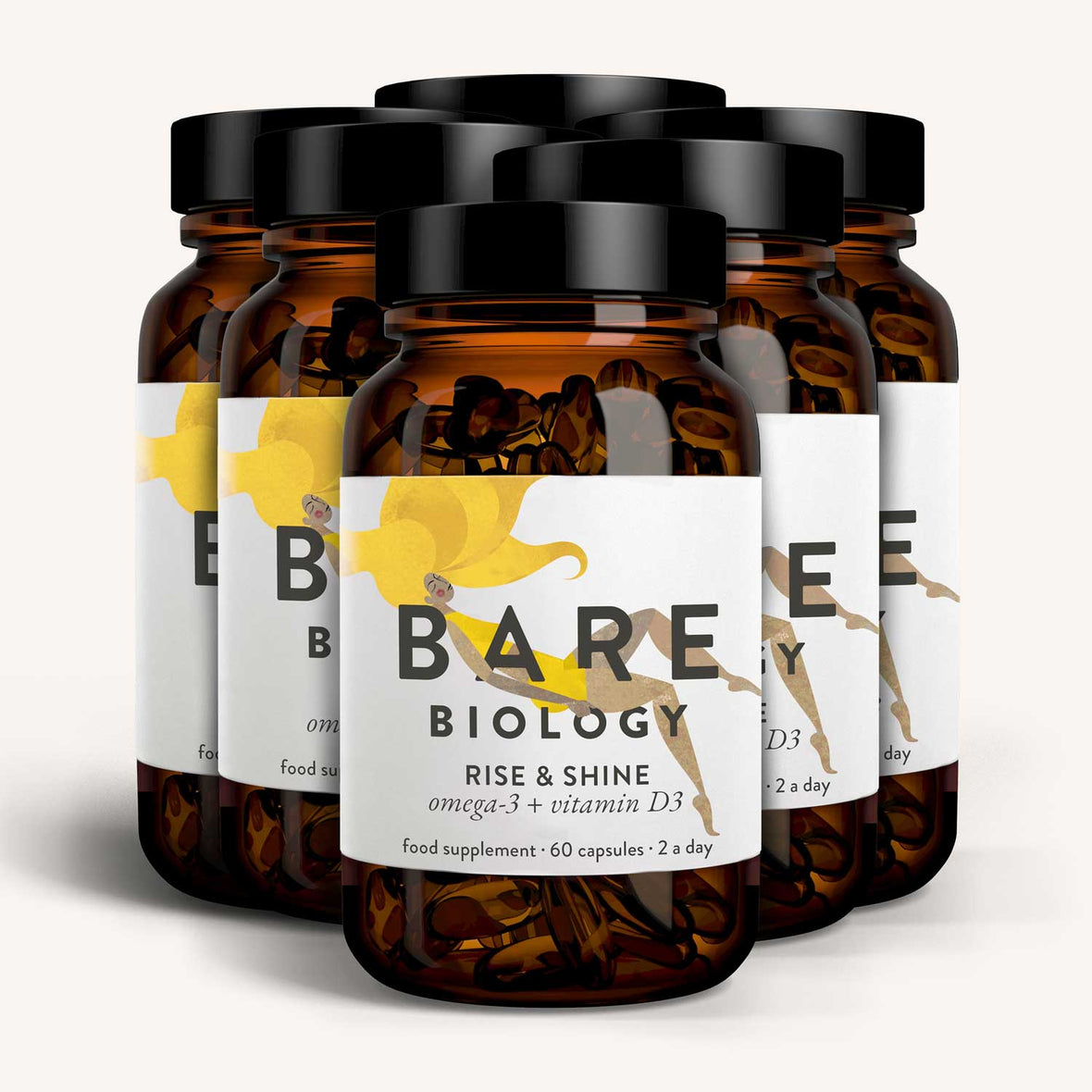 Six amber bottles of Bare Biologys Rise & Shine Omega-3 Plus Vitamin D3 Capsules are elegantly displayed with a white label featuring a yellow design, arranged in two rows on a light background.