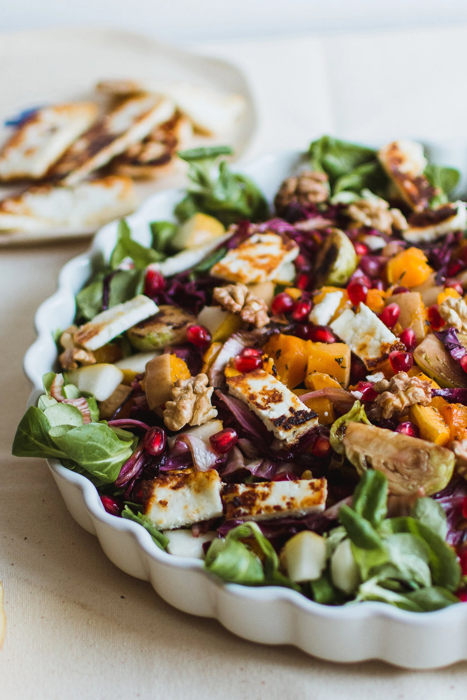 a walnut salad on a white dish
