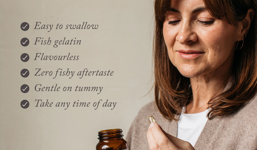 a woman in a brown jumper holding bare biology rise & shine omega 3 vitamin d3 jar and capsule